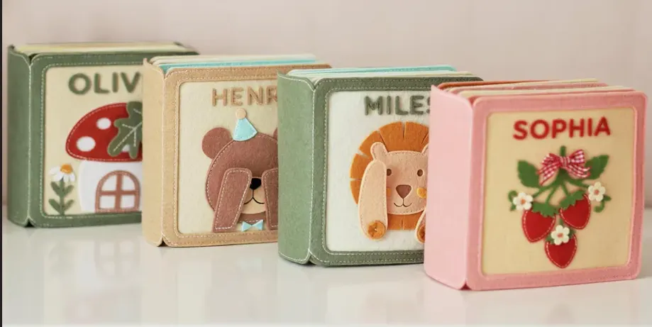 Four personalized quiet books displayed together